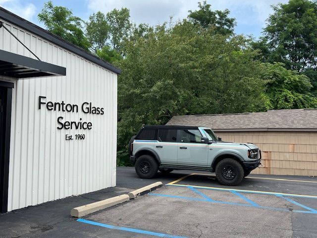 A white building with fenton glass service written on it