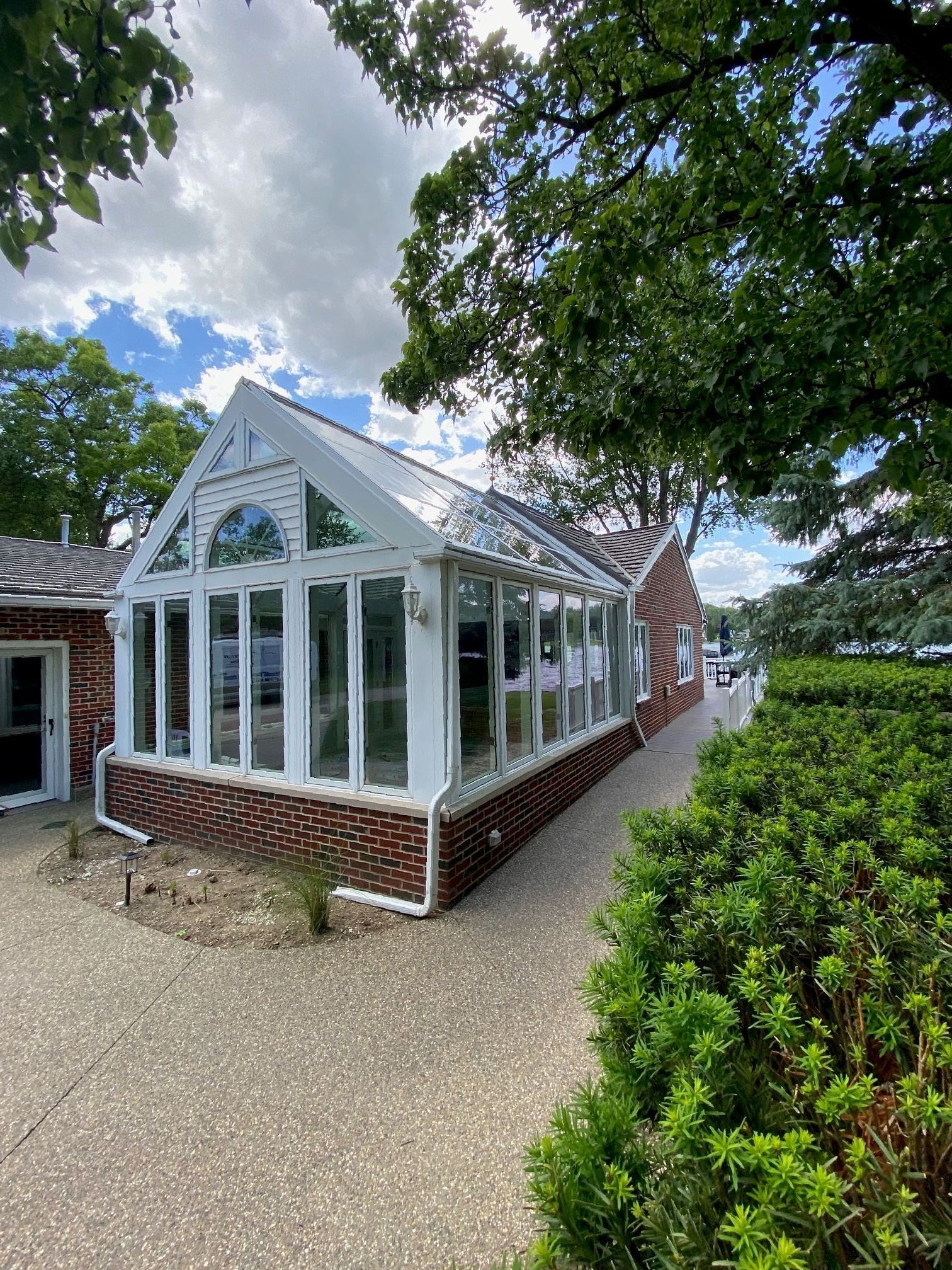 A large house with a lot of windows and a walkway leading to it.
