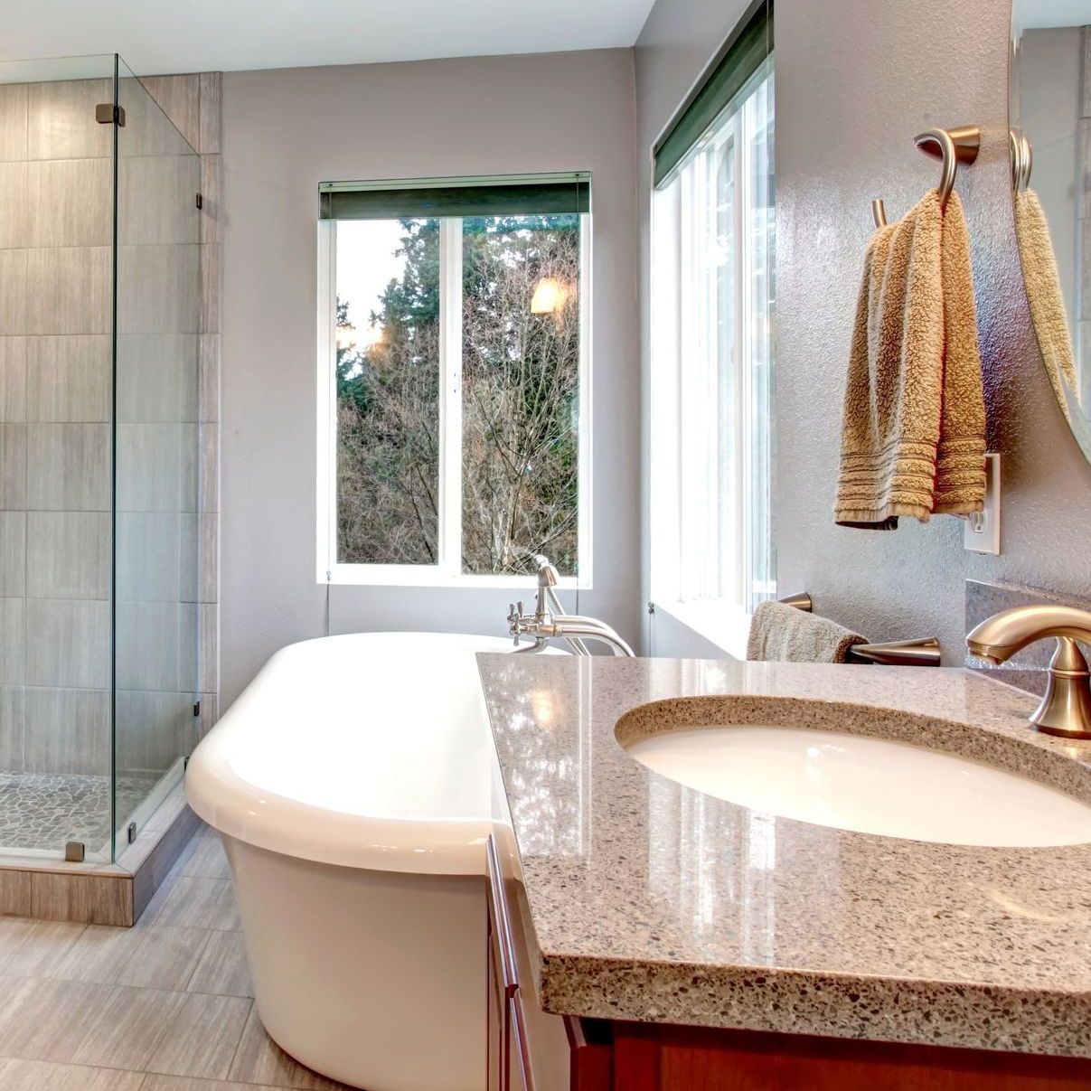 A bathroom with a tub a sink and a window