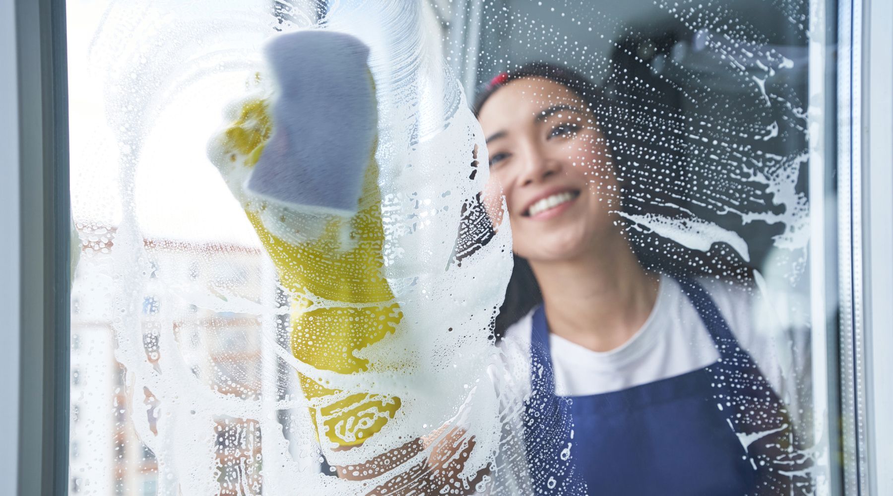 Woman cleaning a window.