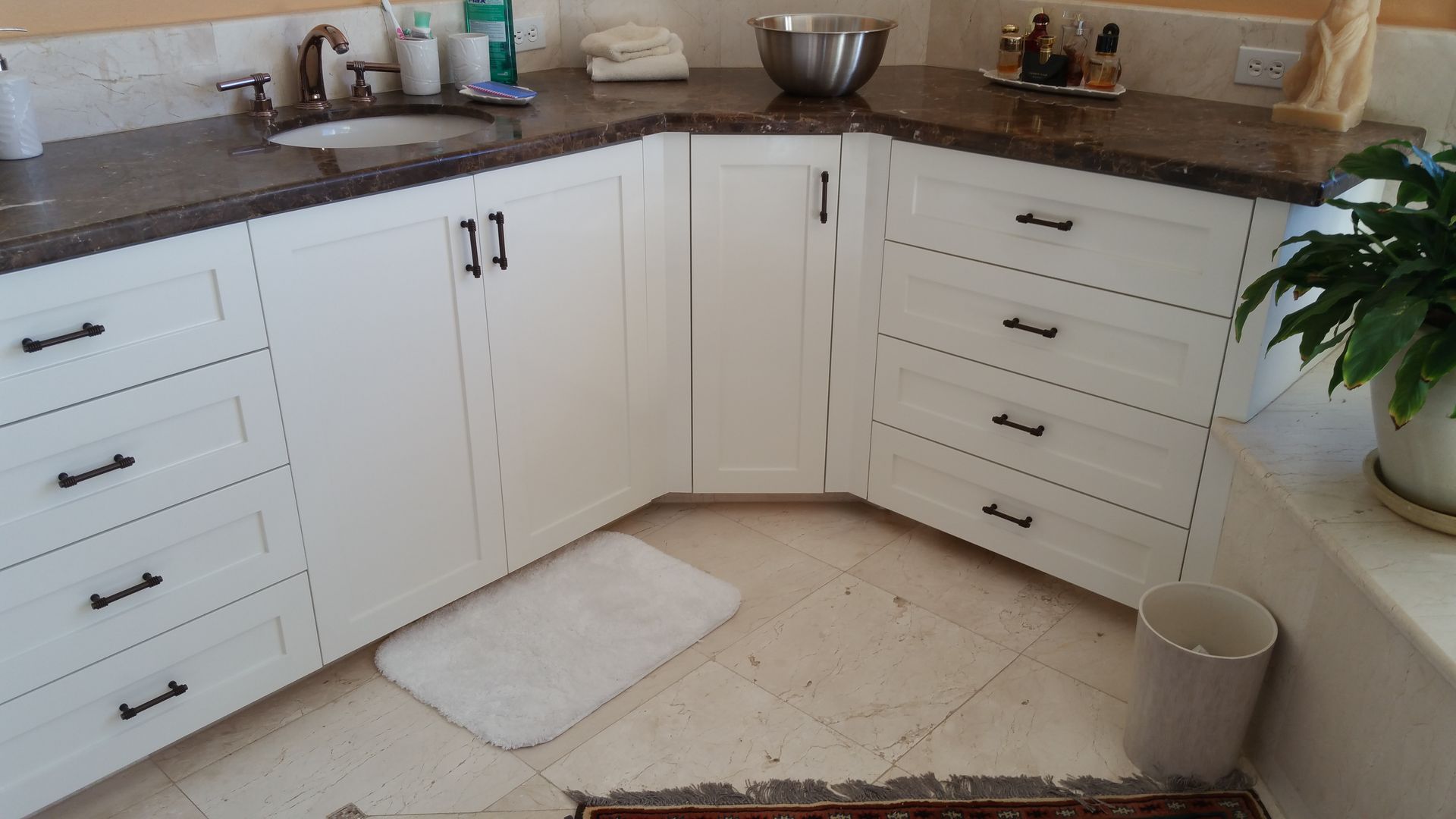A kitchen with wooden cabinets , granite counter tops , stainless steel appliances and a large island.