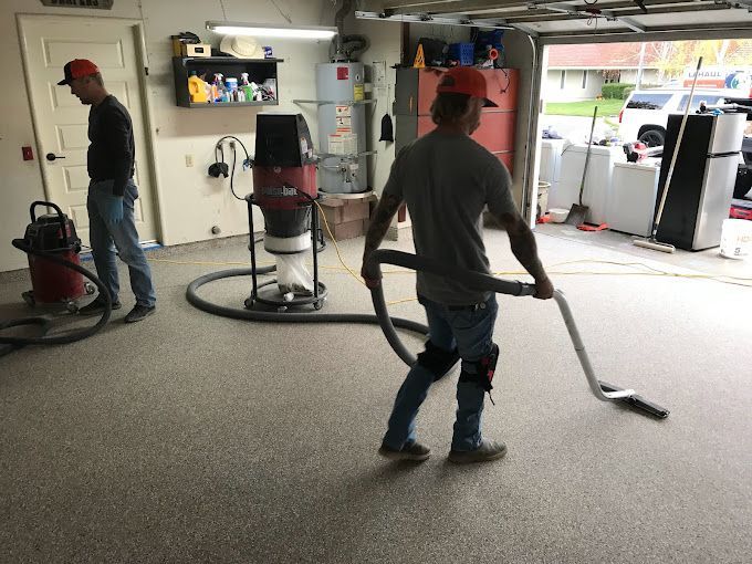 Technician smoothing out concrete floor