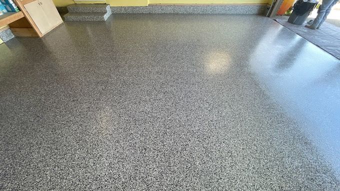 A close up of a shiny concrete floor in a garage.