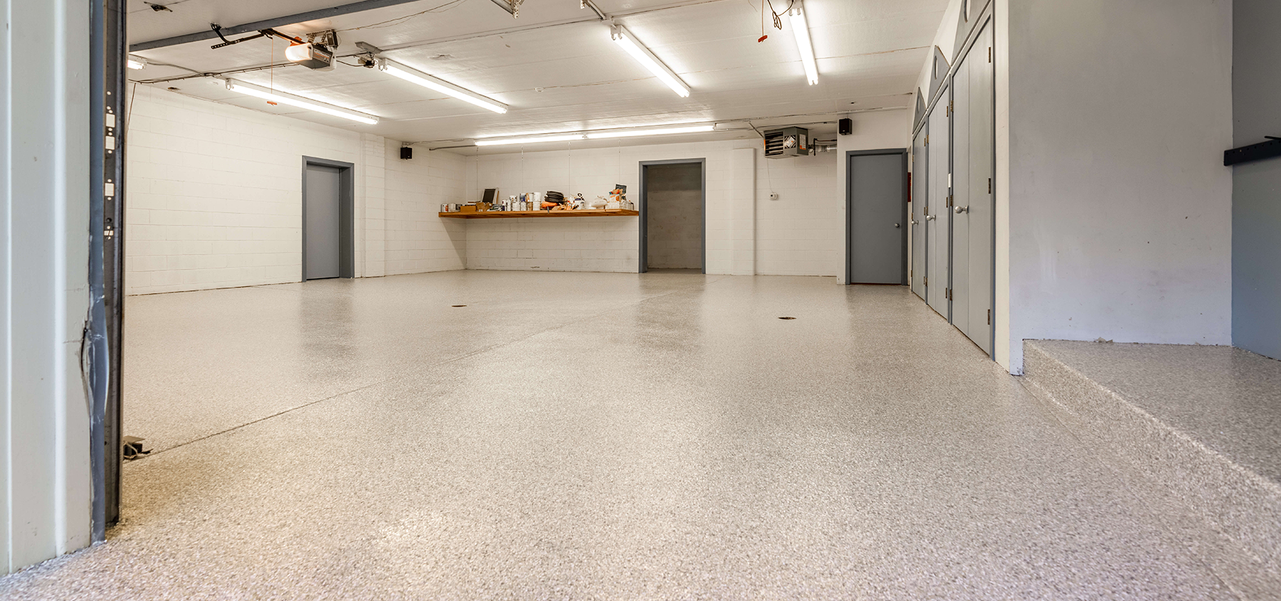 A large empty room with a white floor and white walls.