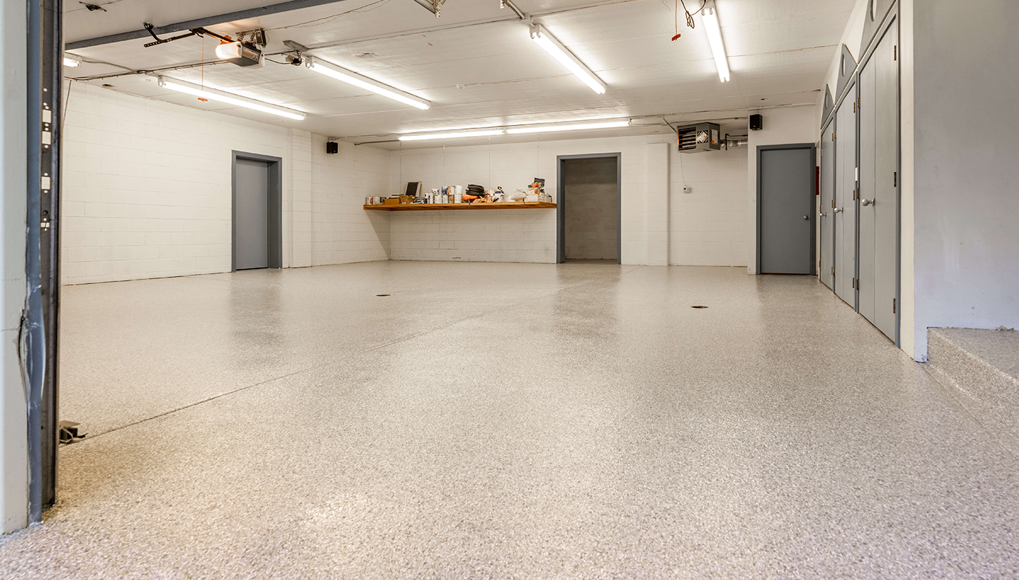 A large empty room with a white floor and white walls.