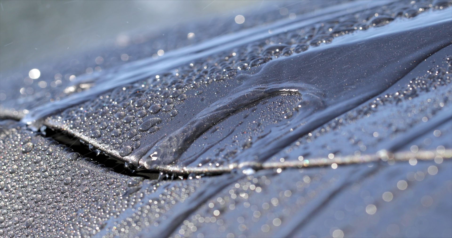 water droplets rolling off car exterior