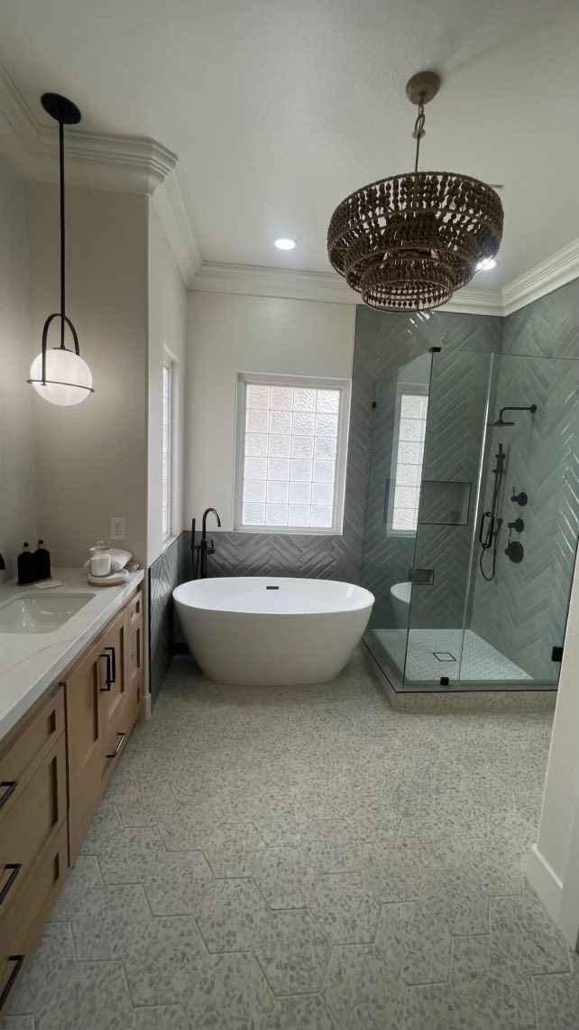 White kitchen with cabinets, countertops, and stove. Stainless steel appliances and tan tile flooring.