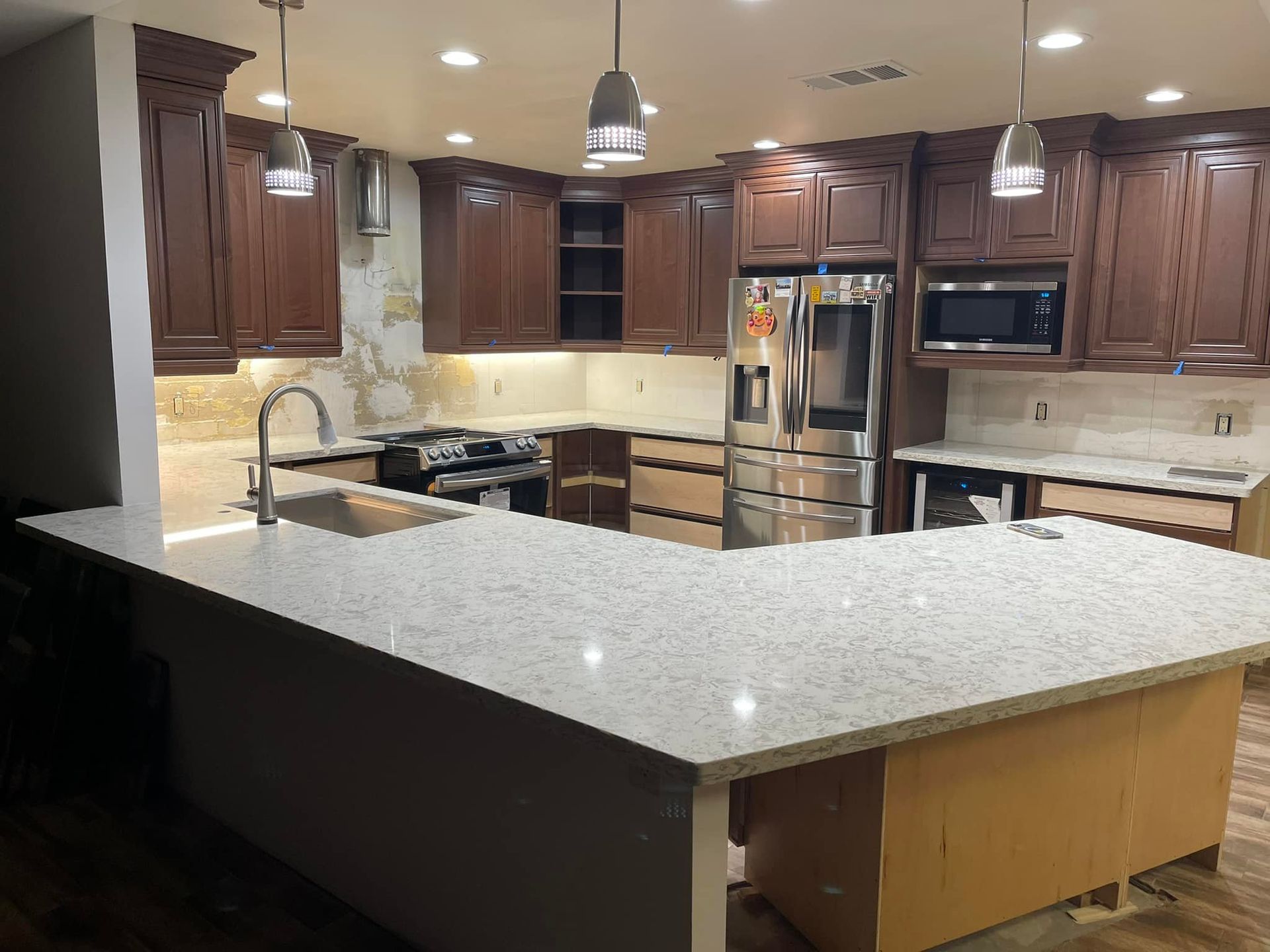Kitchen with white cabinets, granite countertops, and stainless steel appliances.