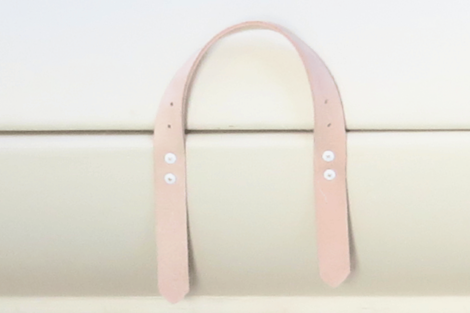 A close up of the natural leather handles of the PeacePod casket coffin.