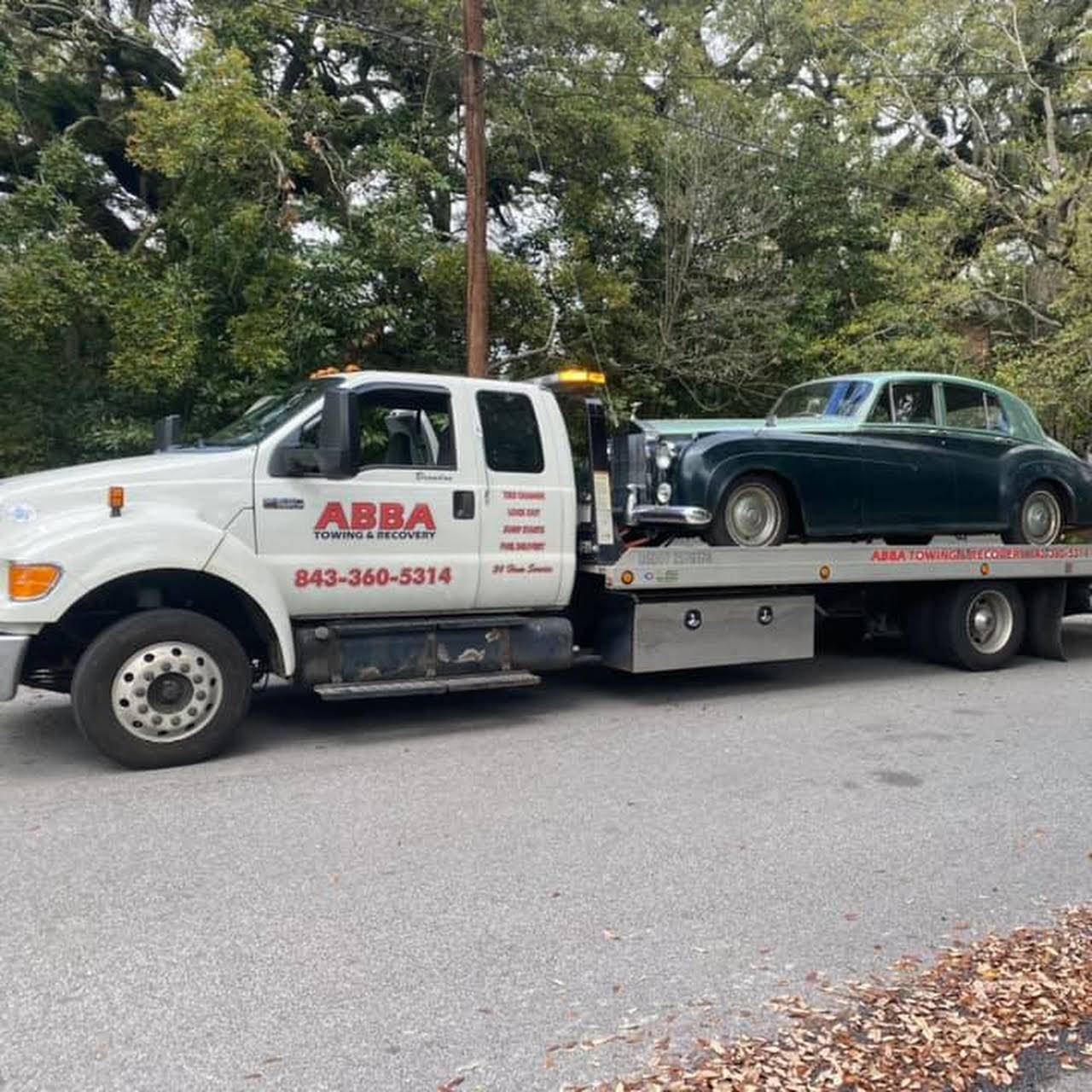 A tow truck with the word abba on the side