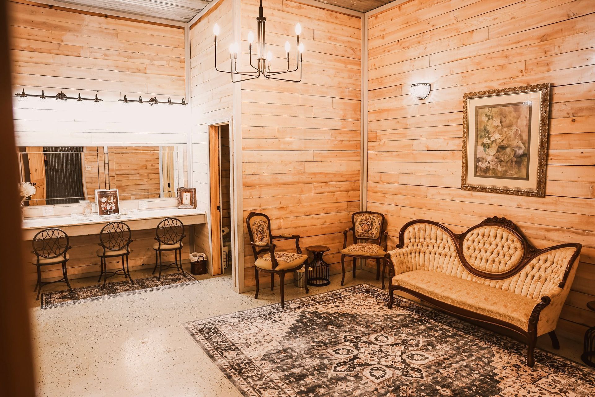 A wedding suite with wood-paneled walls, ornate furniture, a vanity, and a chandelier.