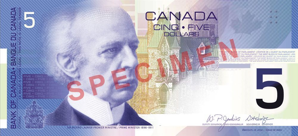 A canadian five dollar bill with a picture of a man on it
