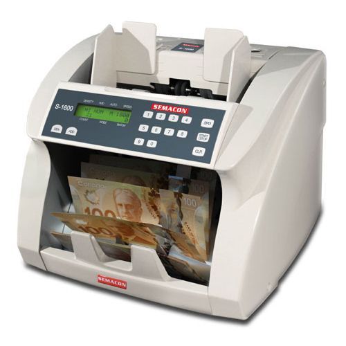 A semacos money counting machine is counting canadian money