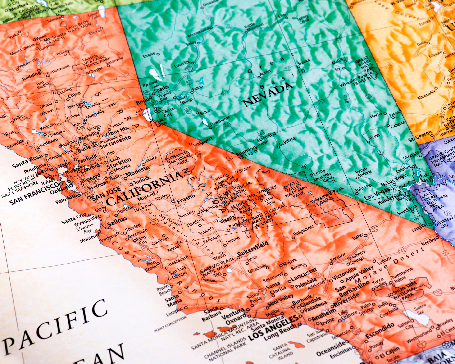 Two men are standing next to each other in front of a white van.