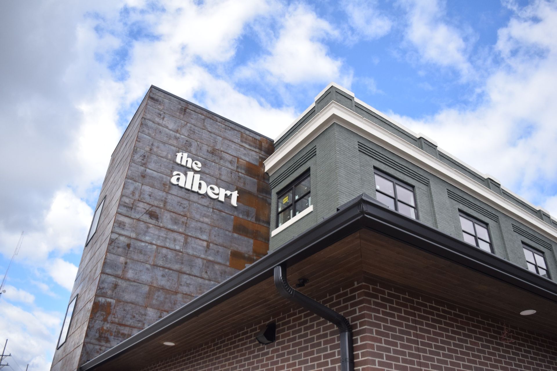 A large brick building with a sign that says the albert on it.