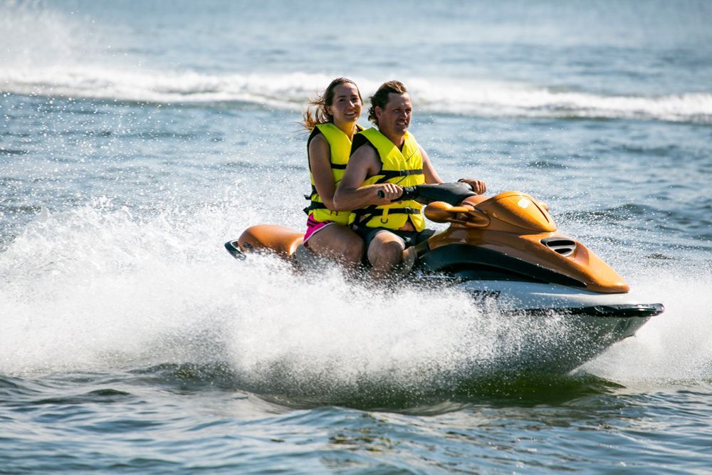 Couple Riding Jet Ski — Hampton, NH — Hampton Bay Insurance Agency