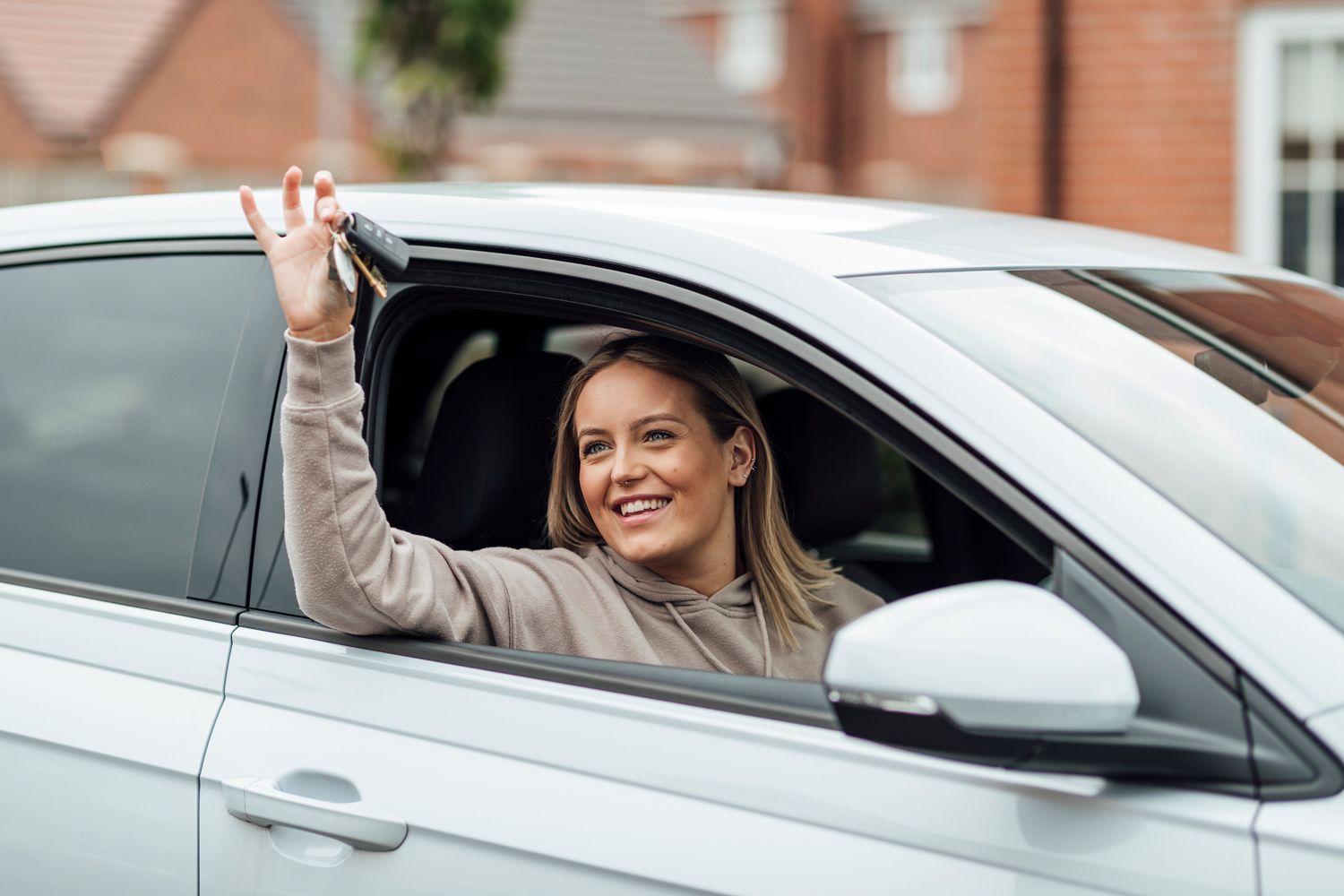 Woman Inside A Car Holding A Key — Hampton, NH — Hampton Bay Insurance Agency