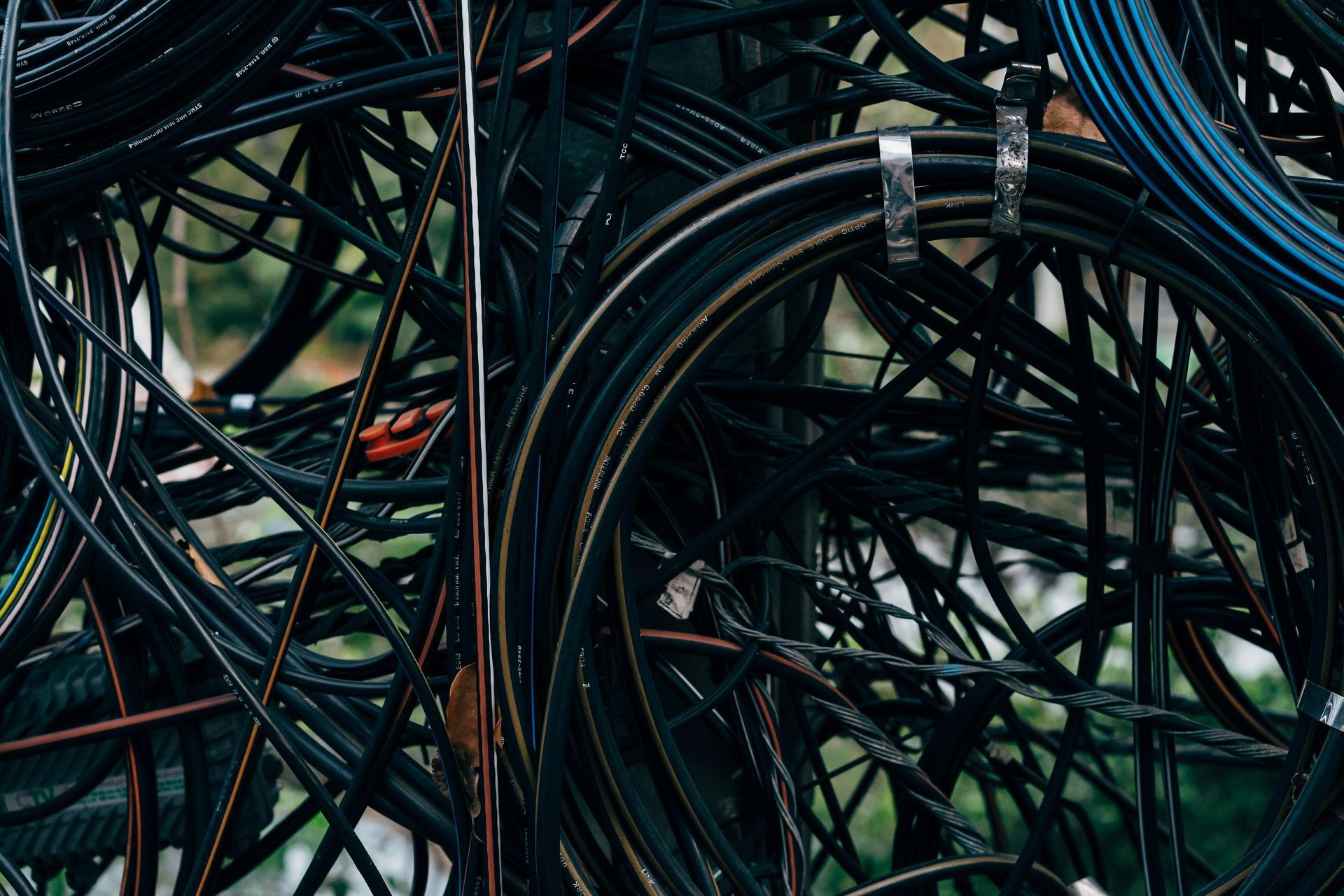 Tangled black and blue cables bundled together in a dense, chaotic mass