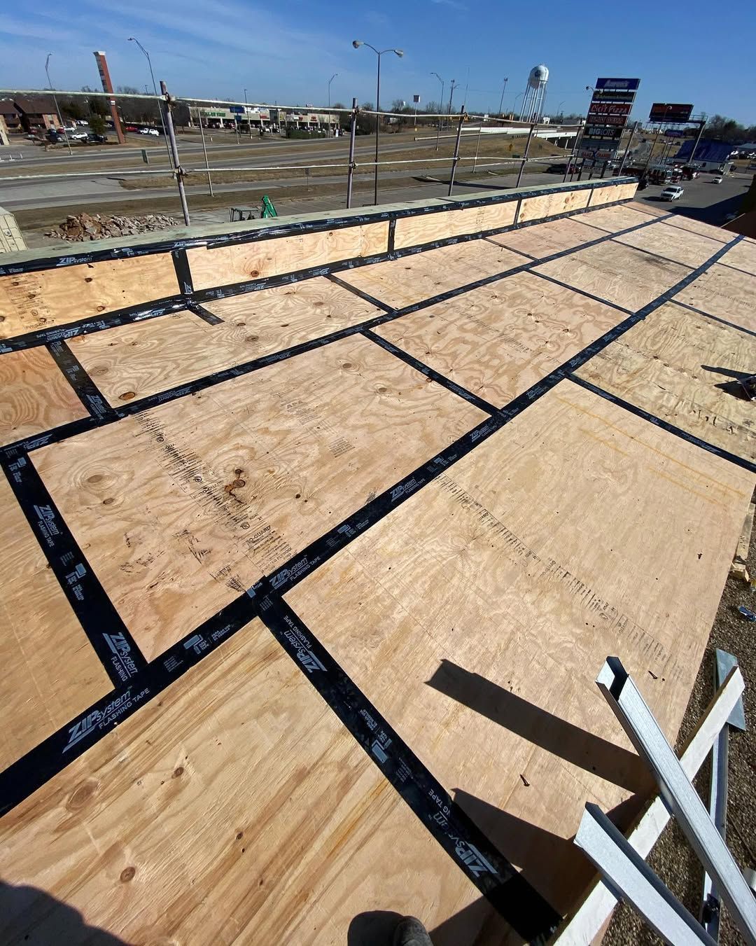 A roof is being built with a lot of plywood