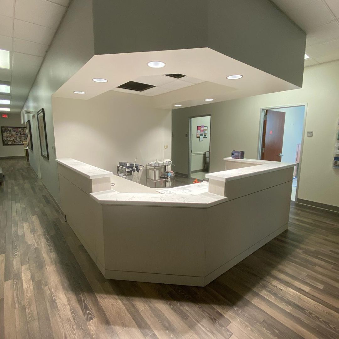 A long hallway with a counter in the middle of it.