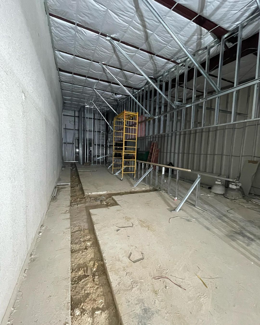 The inside of a building under construction with a scaffolding.