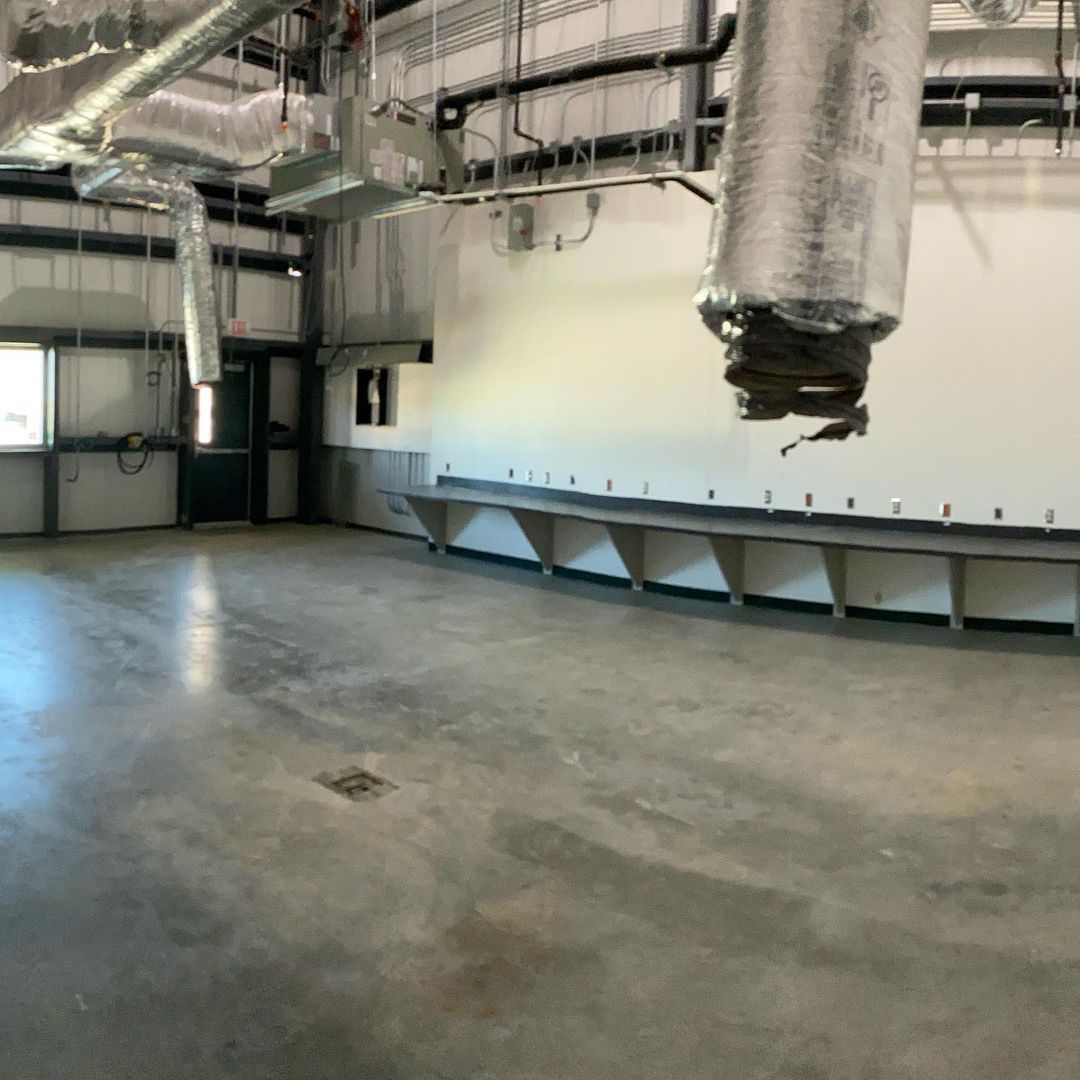 A large room with a lot of pipes hanging from the ceiling