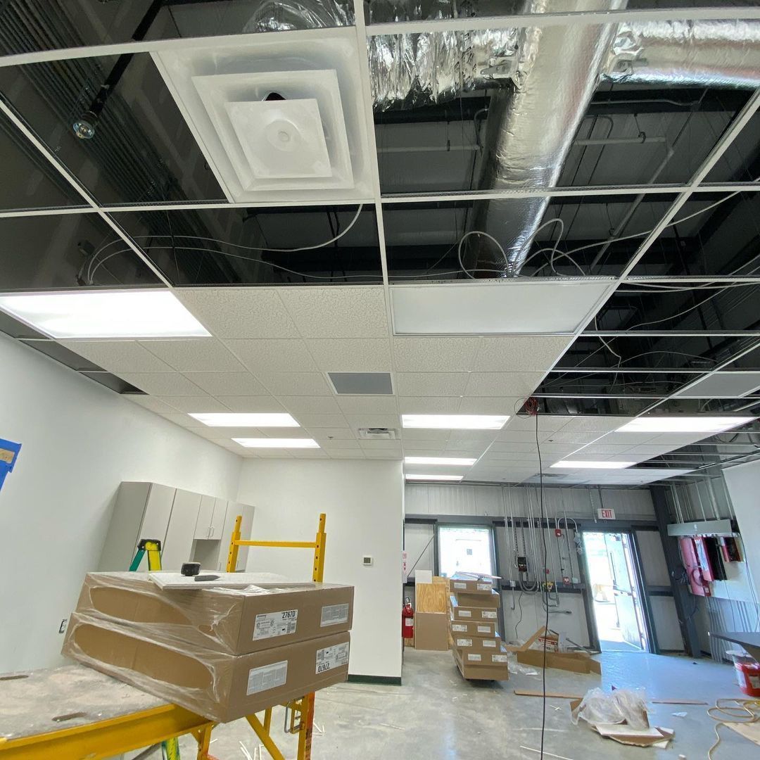 A large room with a ceiling that is being remodeled.