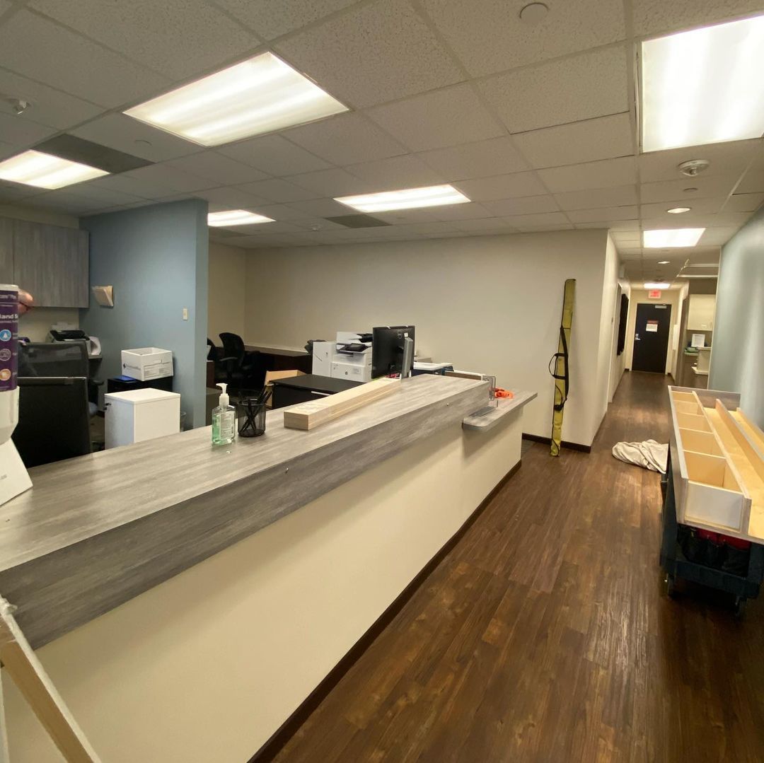 A long hallway with a desk in the middle of it