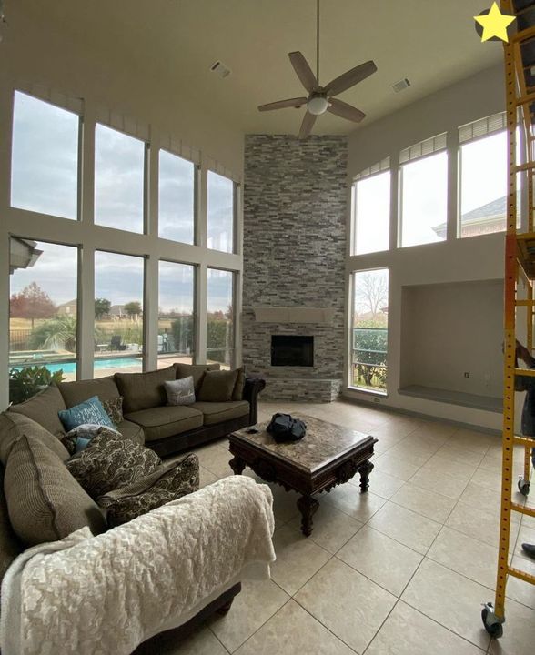 A living room with a couch , chair , coffee table and fireplace.