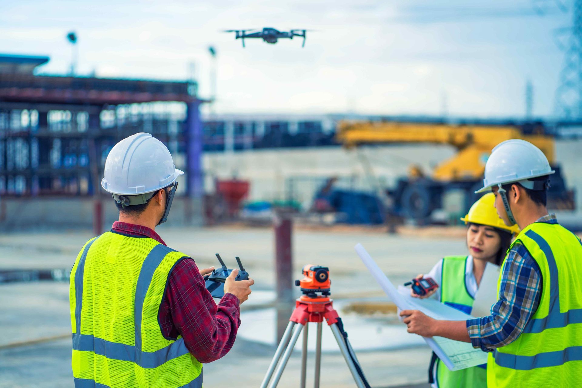 Construction crew using a drone to inspect a worksite