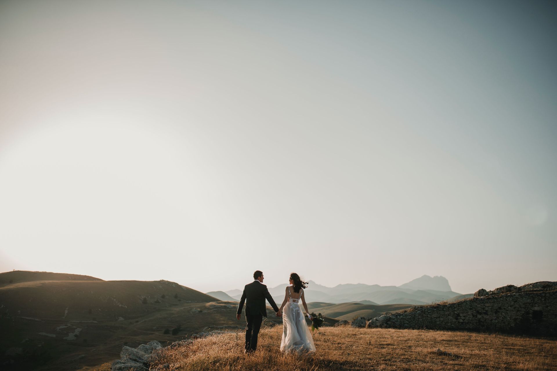 Drone photography of a newlywed couple walking into the sunset in the sierra nevada foothills.