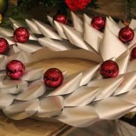 White folded paper flower with red ornaments on a festive holiday arrangement