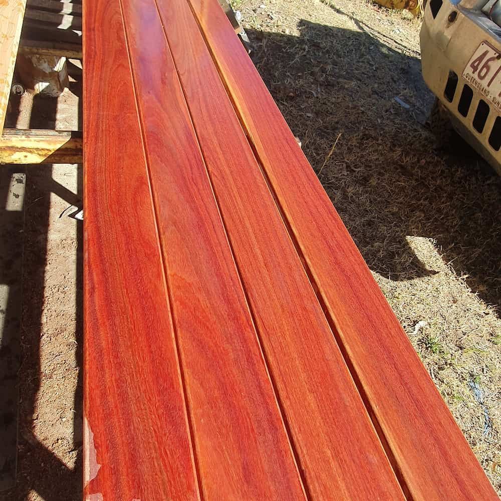 A Wooden Bench With A Yellow Truck In The Background — Eungella Sawmill In Crediton, QLD