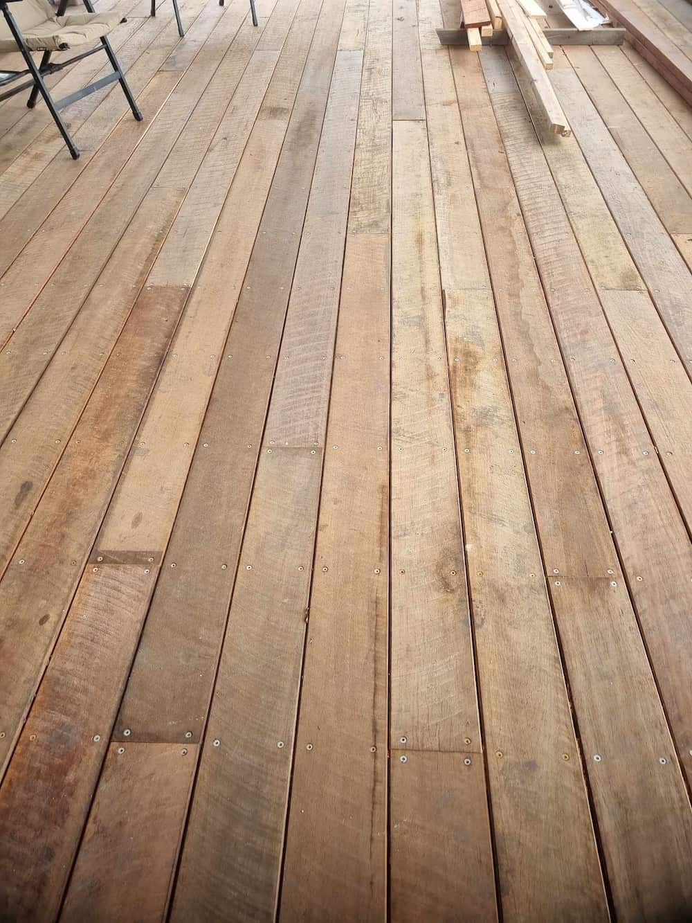 A Wooden Deck With Chairs And Benches On It — Eungella Sawmill In Crediton, QLD