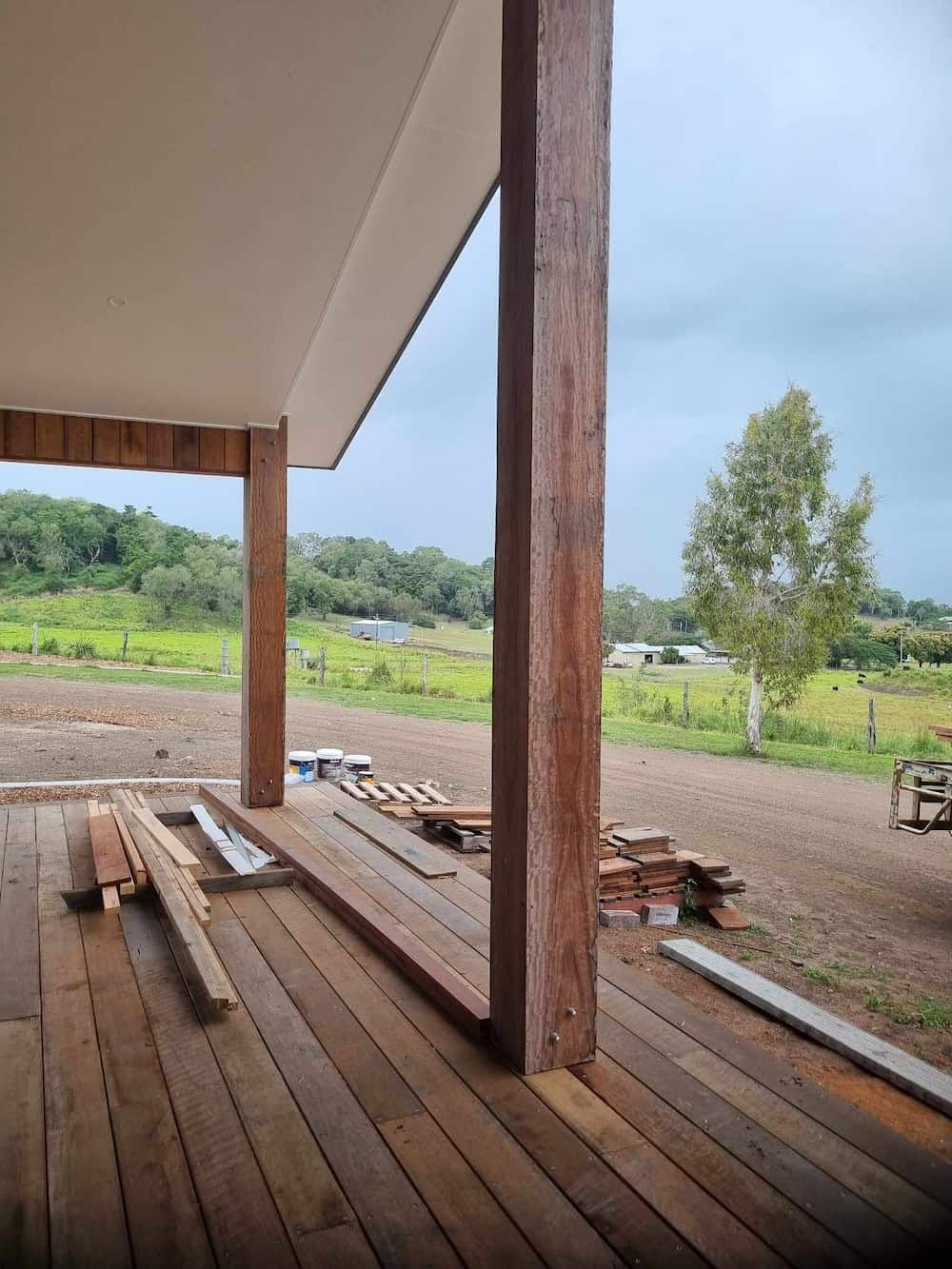 A Wooden Deck With A View Of A Field And Trees — Eungella Sawmill In Crediton, QLD