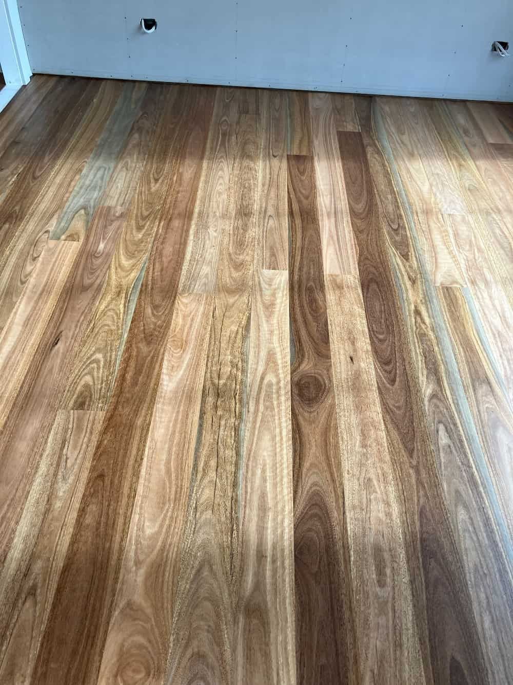 A Man Is Sitting On A Green Tractor In A Field — Eungella Sawmill In Crediton, QLD