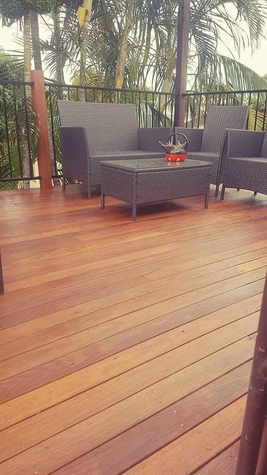 A Wooden Deck With A Couch And Chairs On It — Eungella Sawmill In Crediton, QLD
