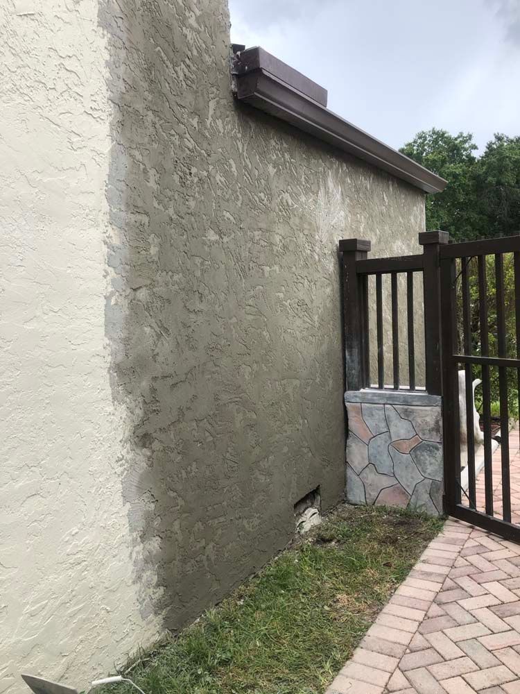 The side of a building is being painted white.