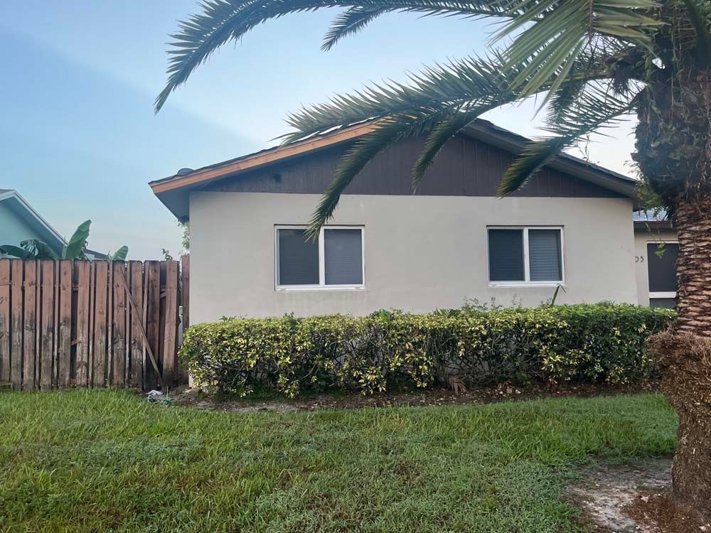 A house with a palm tree in front of it