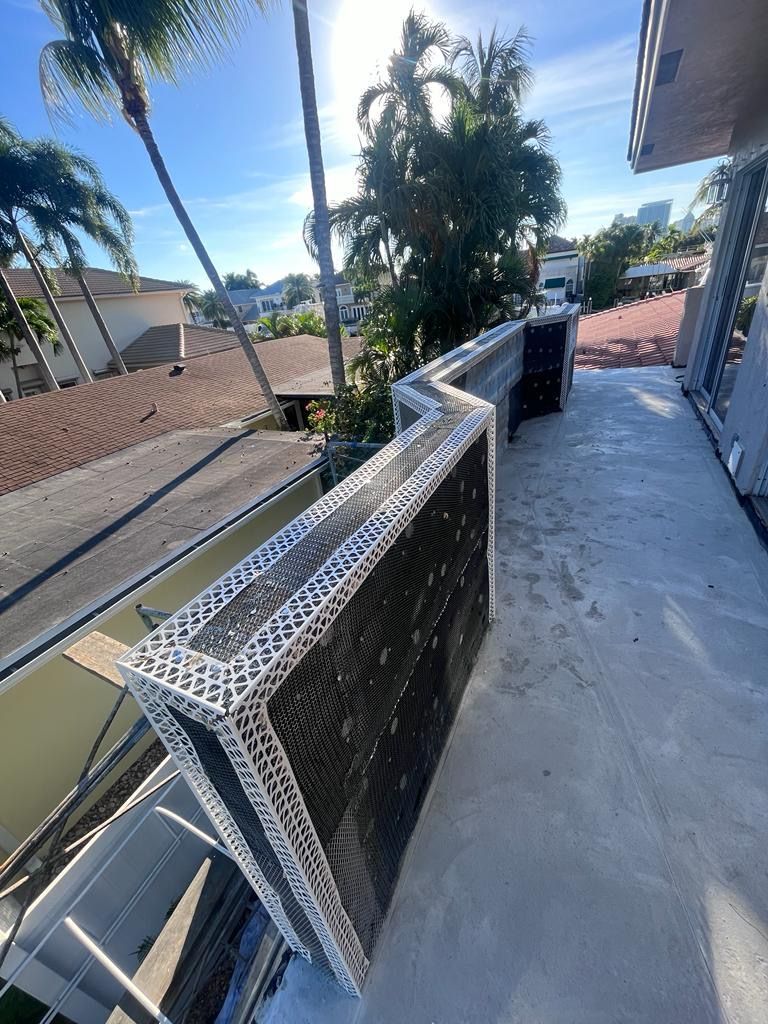 A large air conditioner is sitting on top of a balcony.