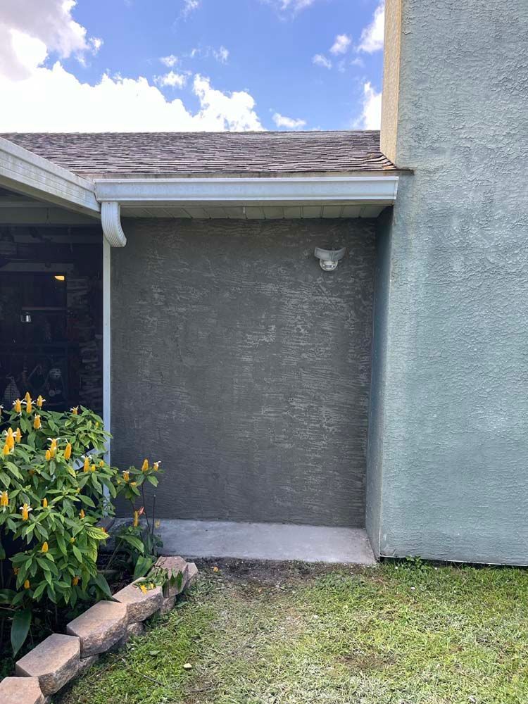 A house with a gutter on the side of it.