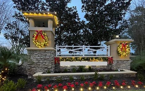 A fence with a wreath on it is decorated for christmas