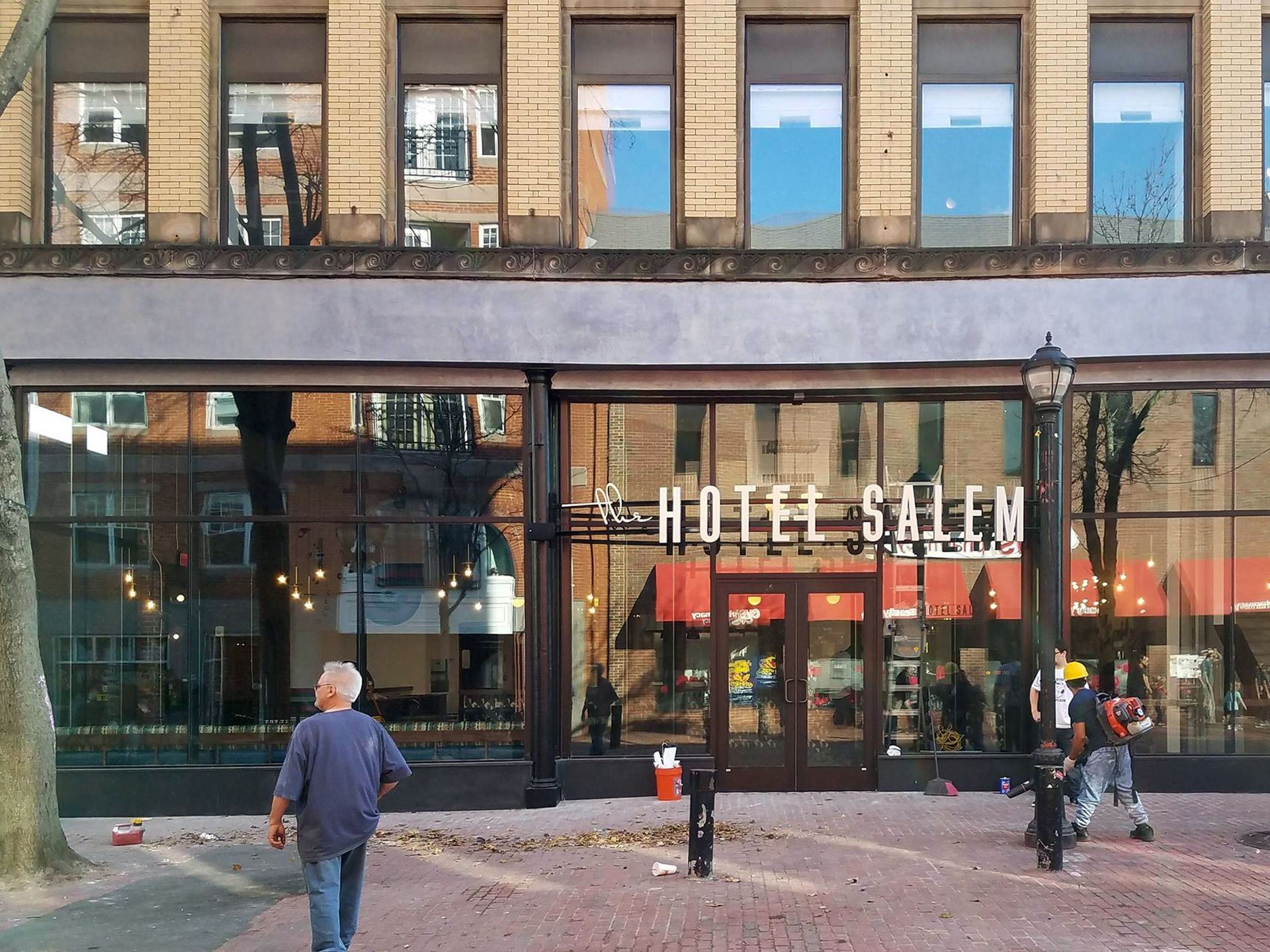 A man walks in front of the hotel salem.
