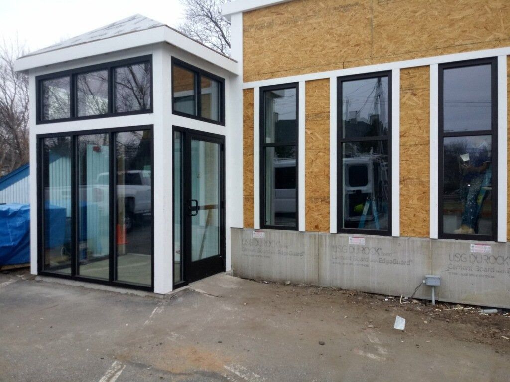 A building under construction with a lot of windows and doors.