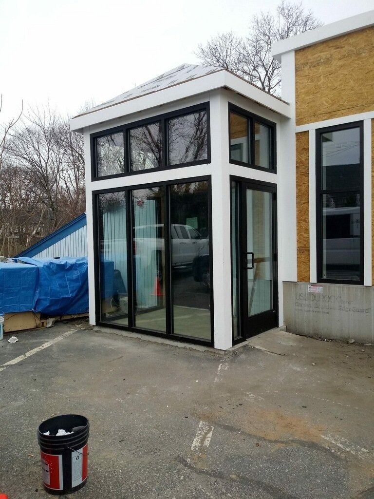 A building with a lot of windows and a bucket in front of it.