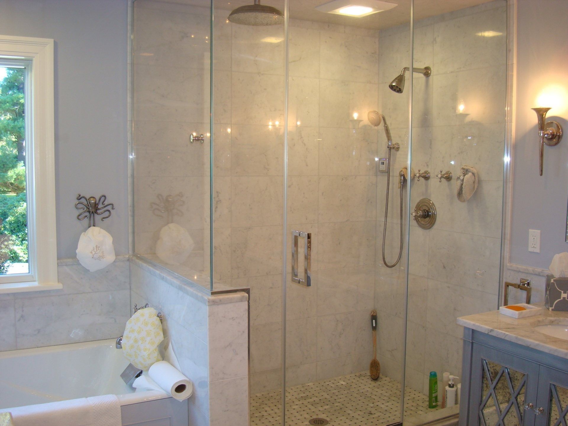 A bathroom with a walk in shower and a bathtub.
