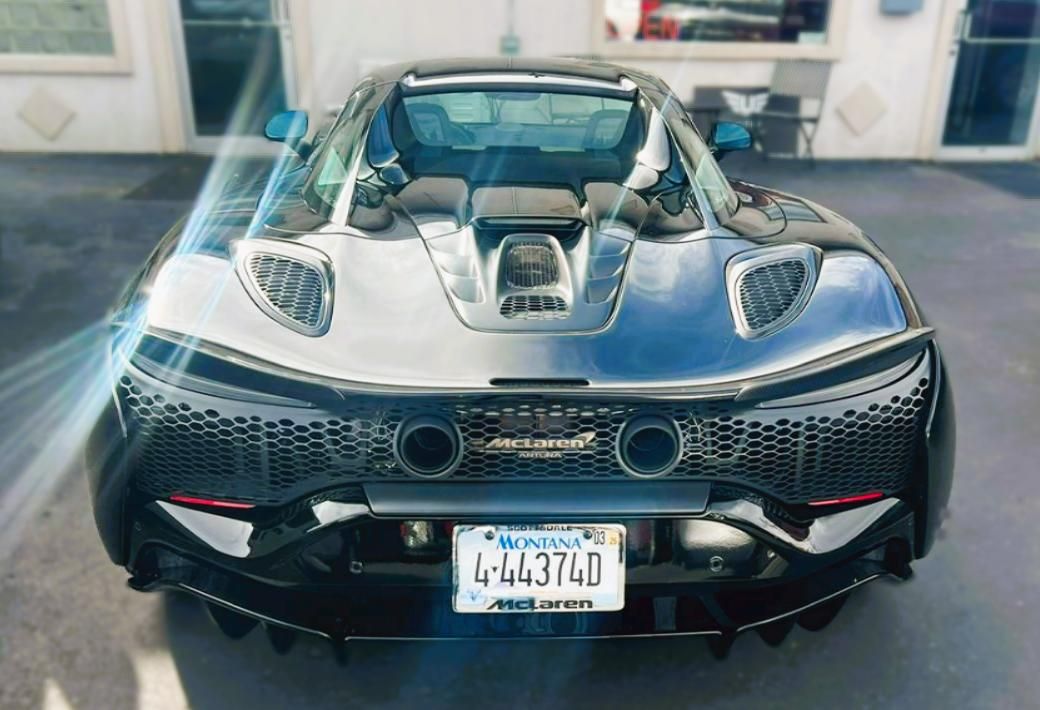 Rear view of a black McLaren sports car with Nevada license plate.