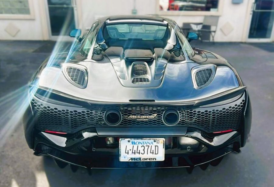 Rear view of a black McLaren sports car with Nevada license plate.