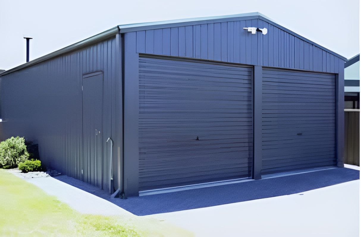 A Blue Garage With Two Garage Doors and a Roof — Goulburn Roofing In Mittagong, NSW