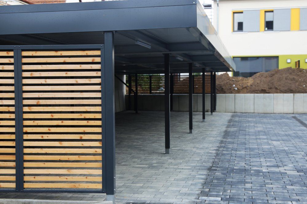 A Carport With a Wooden Fence in Front of a Building — Goulburn Roofing In Goulburn, NSW